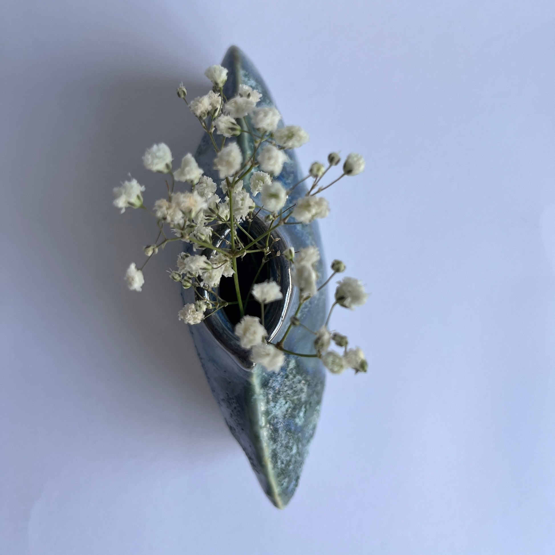 Blue Grey Green textured Porcelain Vase photo from above with gypsophila