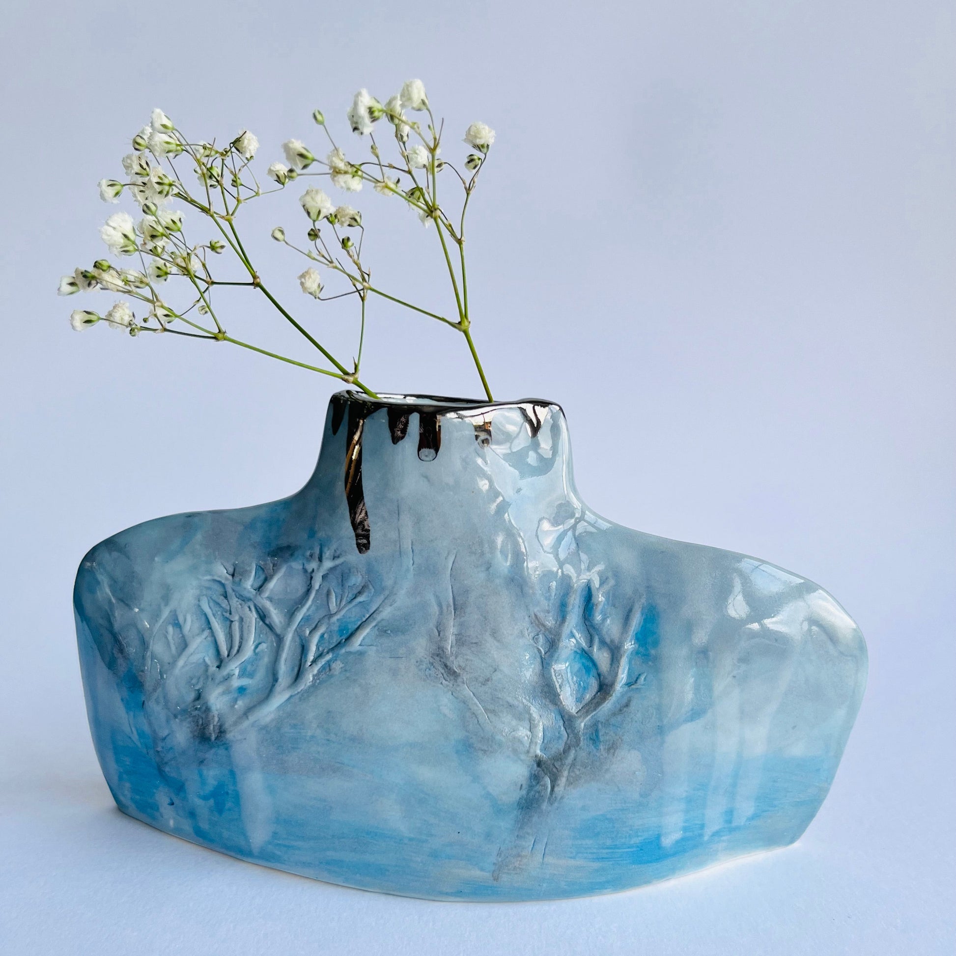 Blue & Grey Porcelain Silhouette Winter Trees Bottle Vase with gypsophila flowers inside