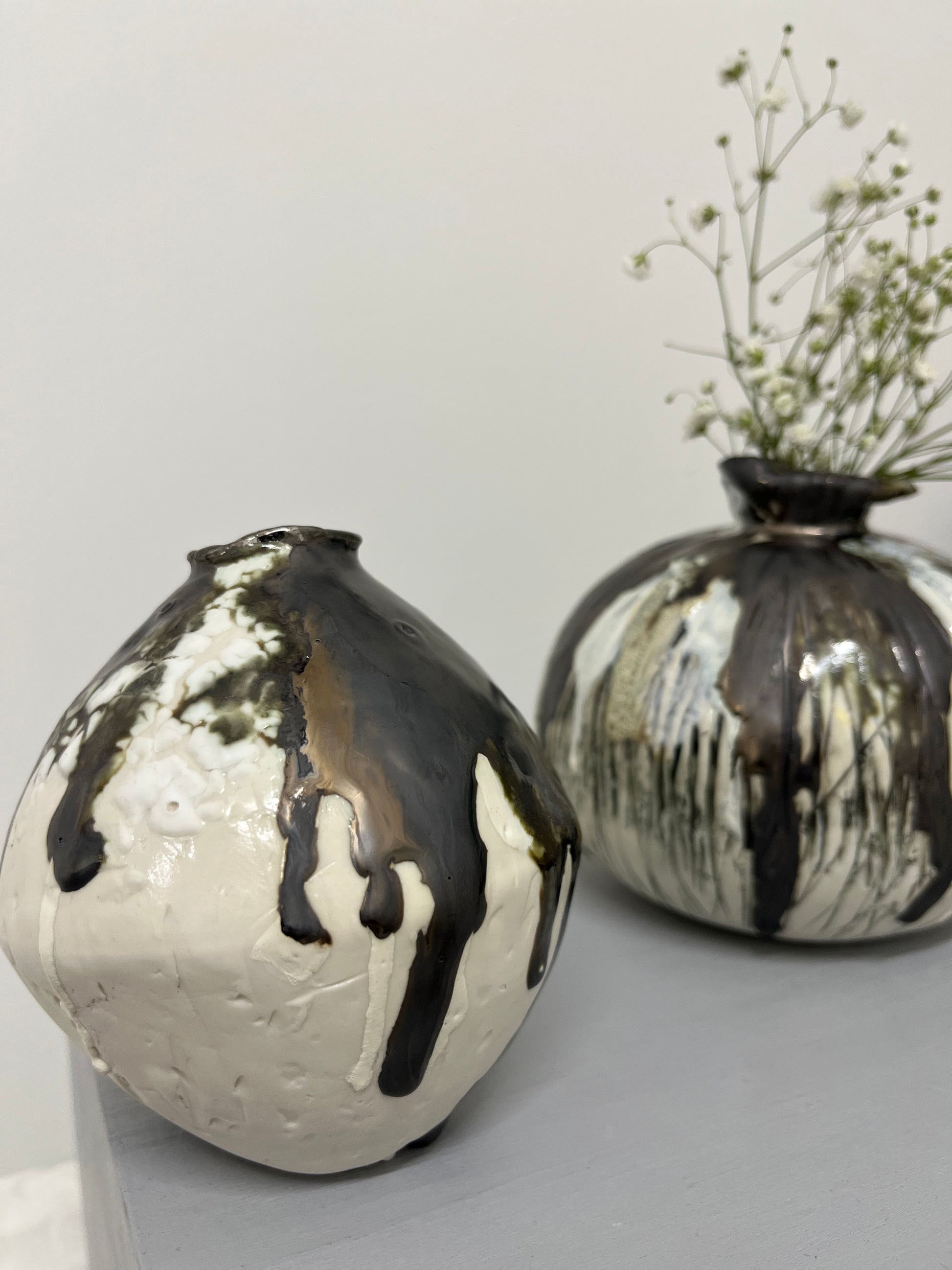 Two textured moon jars with gypsophila flowers displayed inside by Nicola Briggs Ceramics & Art