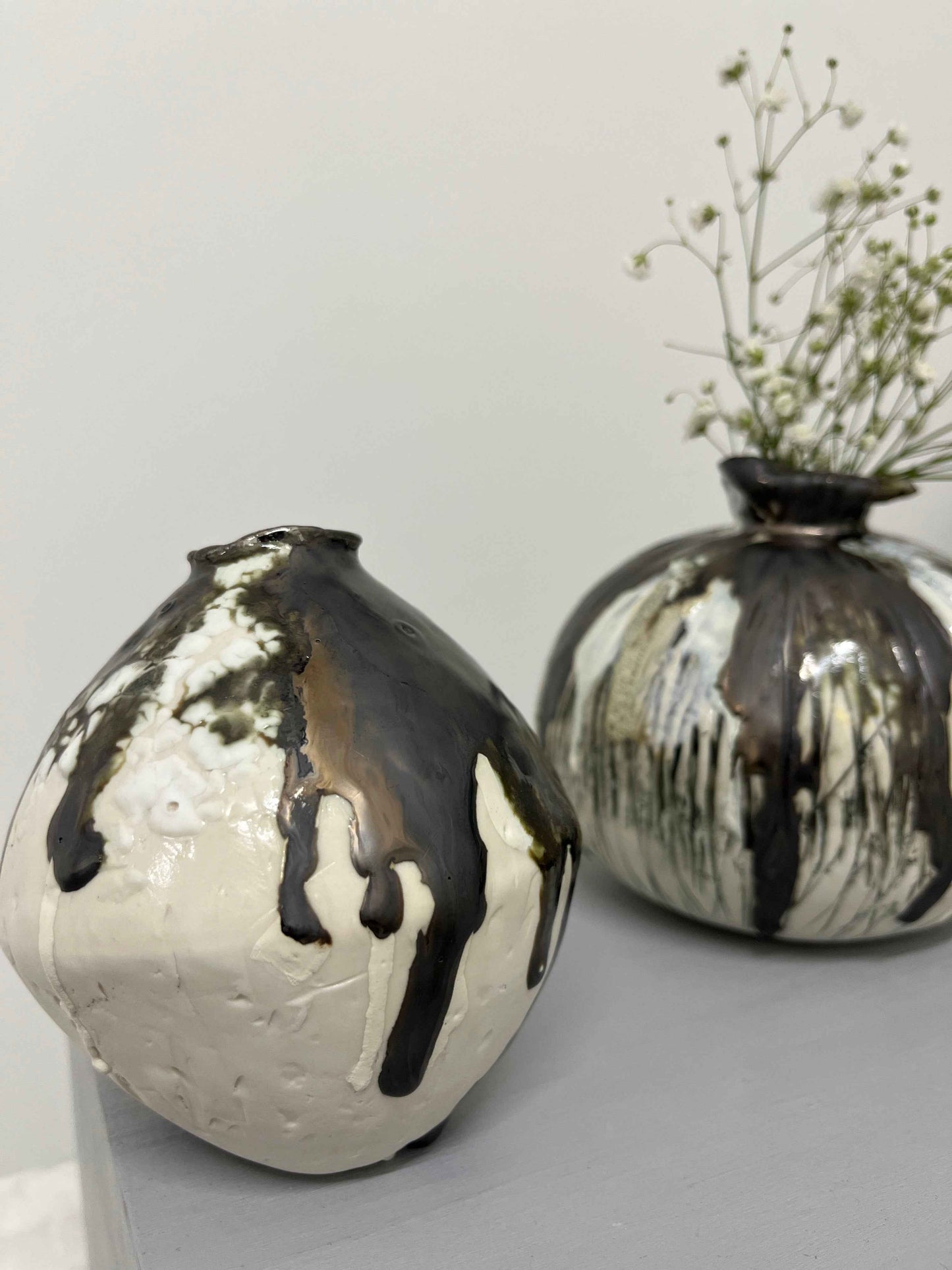 Two textured moon jars with gypsophila flowers displayed inside by Nicola Briggs Ceramics & Art