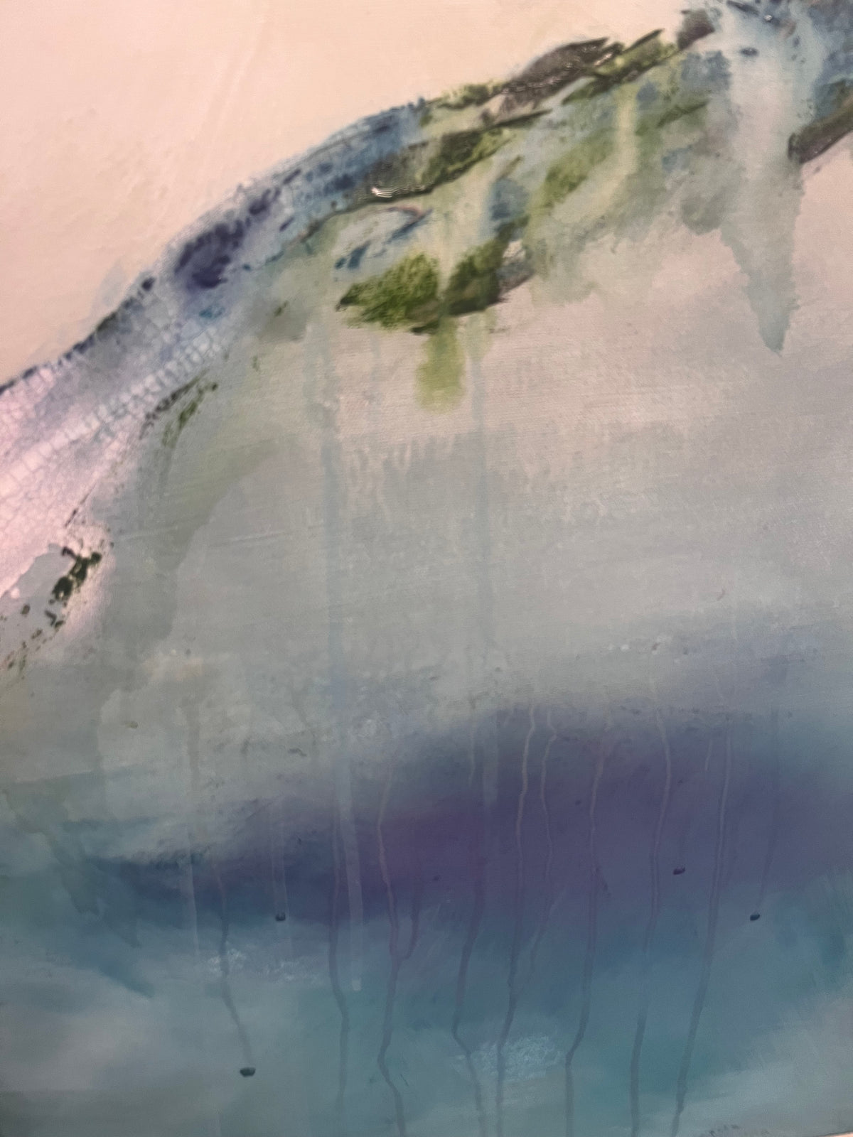 Abstract landscape painting featuring a wave-like form in shades of blue, green, and grey, with dripped paint details and a pale pink background.
