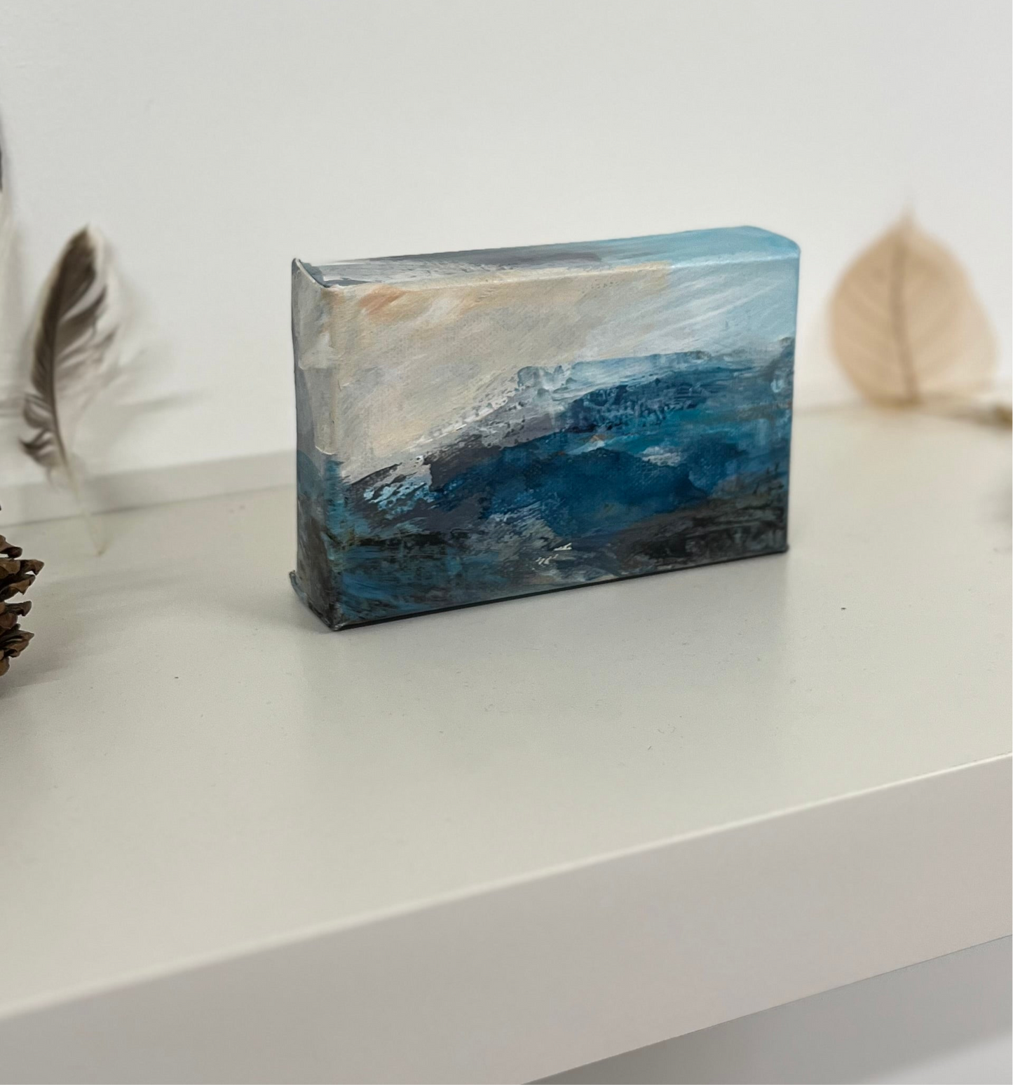 Fragments of Calm III small landscape painting by British contemporary Landscape artist Nicola Briggs photo shows box canvas on studio shelf for size