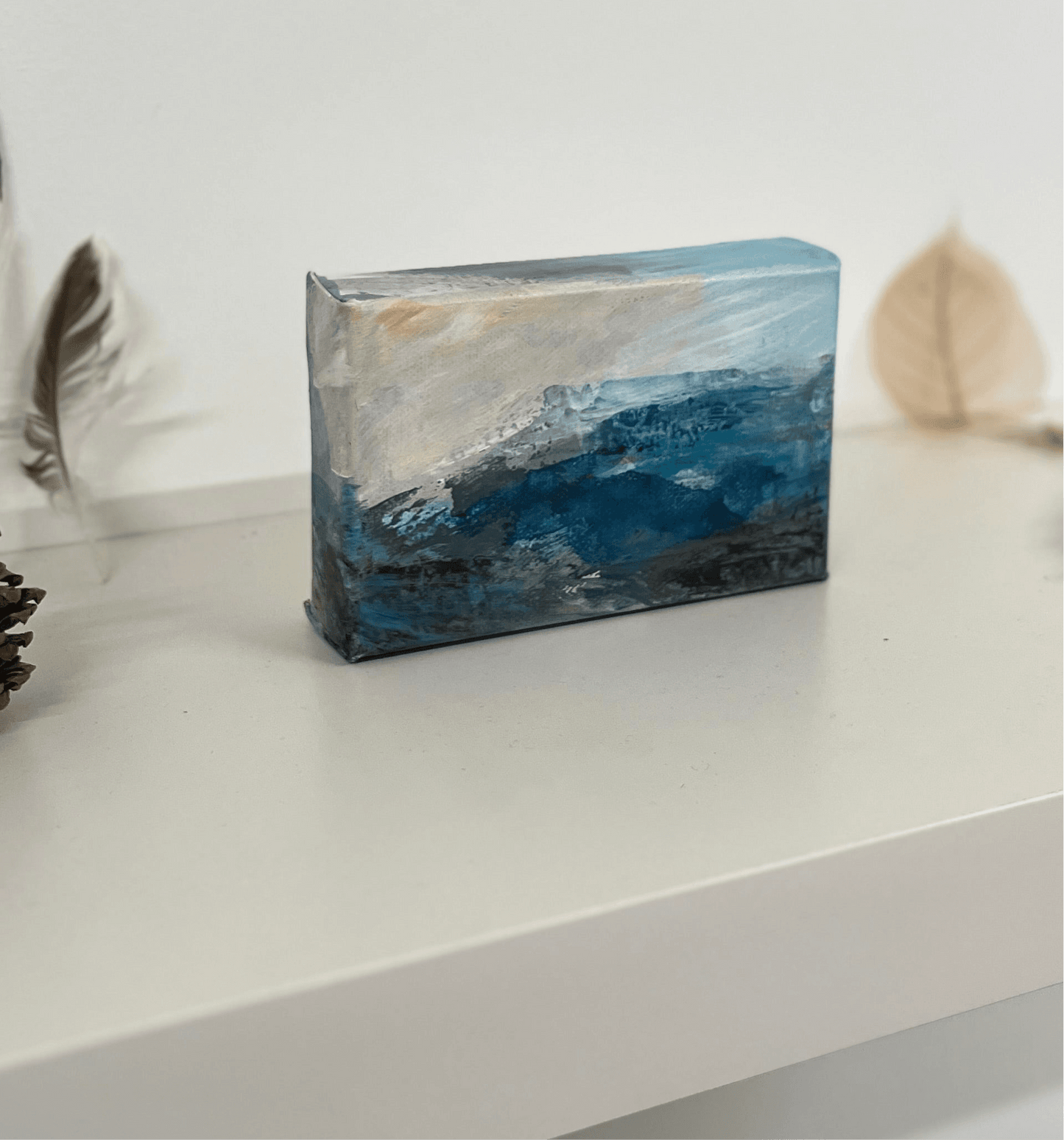 Fragments of Calm III small landscape painting by British contemporary Landscape artist Nicola Briggs photo shows box canvas on studio shelf for size