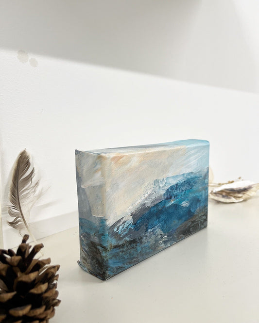 Fragments of Calm III small landscape painting by British contemporary Landscape artist Nicola Briggs photo shows box canvas on studio shelf with nature finds for size