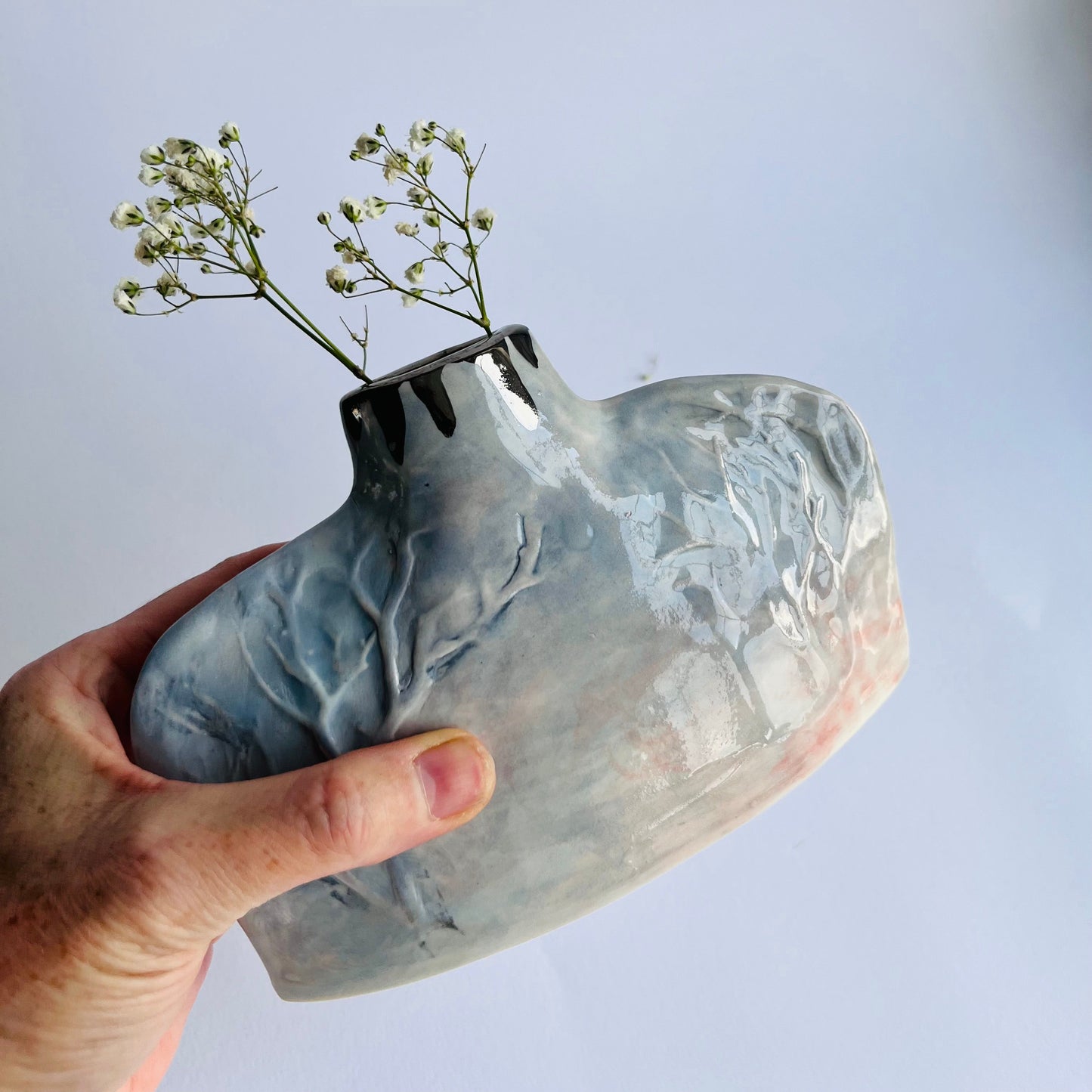 Grey and Pink Silhouette Handbuilt Porcelain Winter Tree Vase in hand