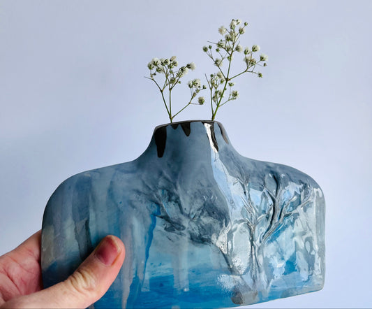 Hand holding Blue & Grey Silhouette Porcelain Vase with Winter Tree Design by Nicola Briggs Ceramics and Art