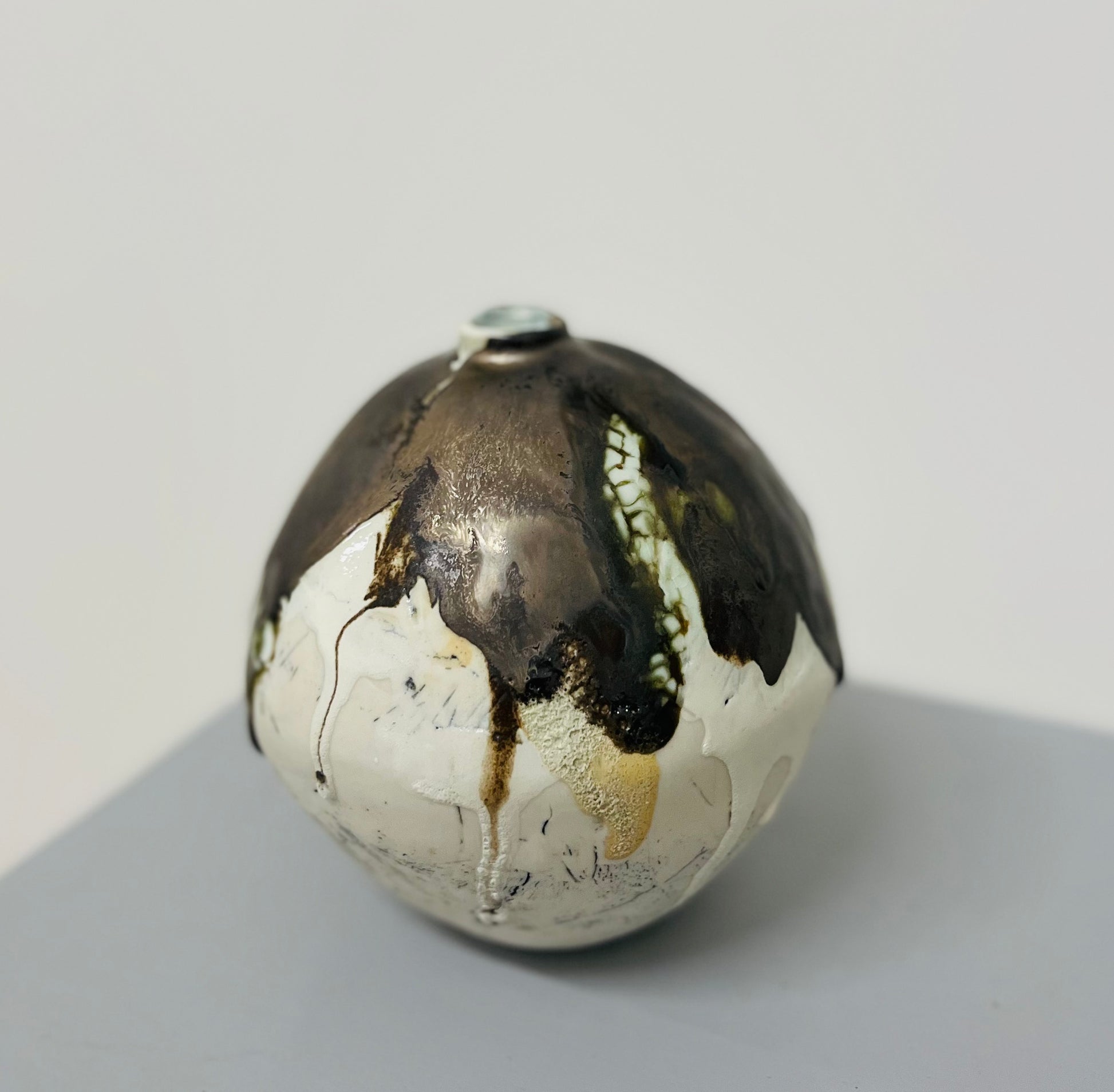 Textured and metallic glazes on the organic shaped moon jar by Nicola briggs