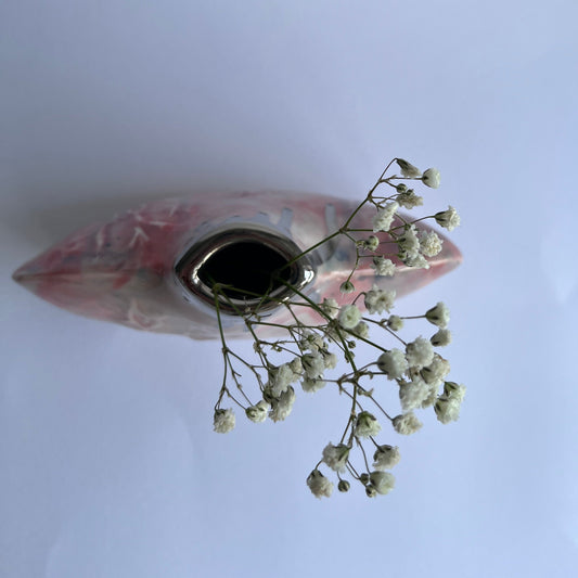 Pink silhouette bottle vase from above with flowers inside handbuilt by Nicola Briggs