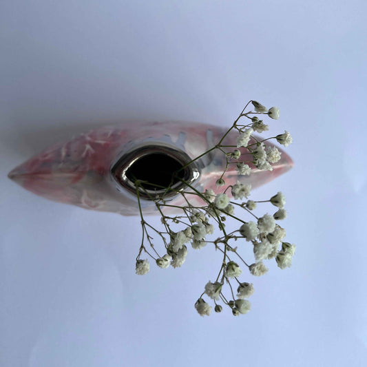 Pink silhouette bottle vase from above with flowers inside handbuilt by Nicola Briggs