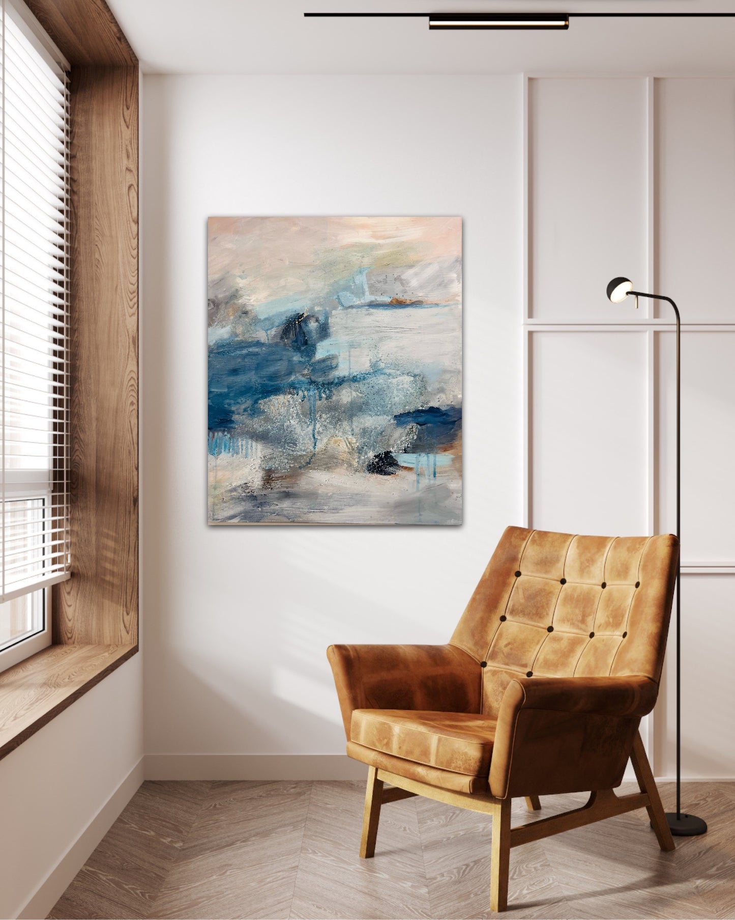 Peach skies and blue and grey details are painted in this atmospheric abstract landscape painting  photo is on a wall near a window, with mustard chair in front