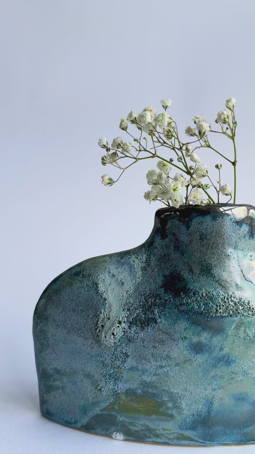 Green and Blue Flat Bottle Vase in Porcelain with textured glaze, platinum drips and gypsophila inside