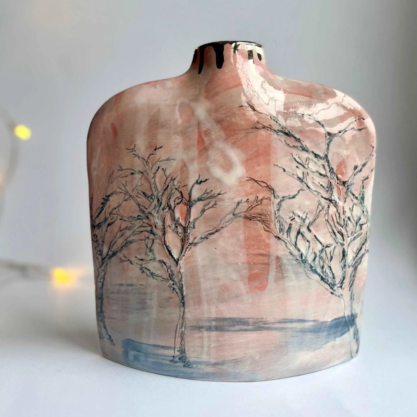 Vase with artistic tree design on a neutral background
