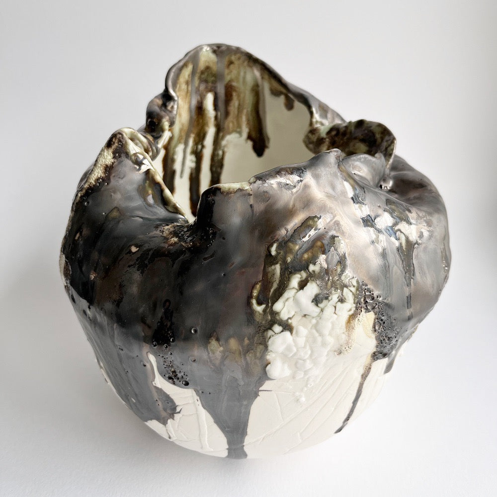 Large organic shaped open vessel in porcelain with bronze and brown glazes 