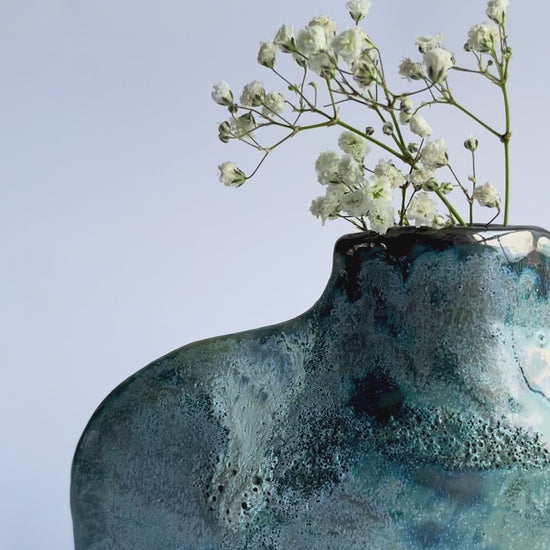 Green and Blue Flat Bottle Vase in Porcelain with textured glaze, platinum drips and gypsophila inside 